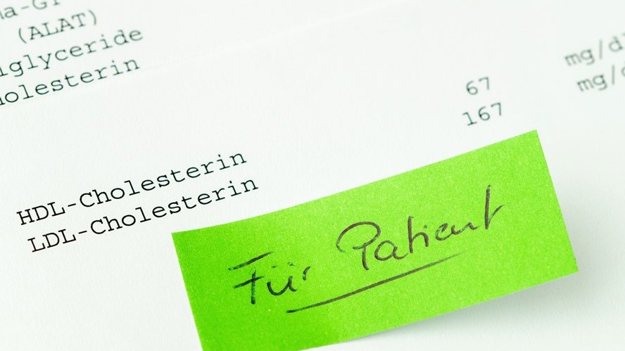 Farbiger Zettel mit der Aufschrift "Für Patient" mit einem Blatt im Hintergrund